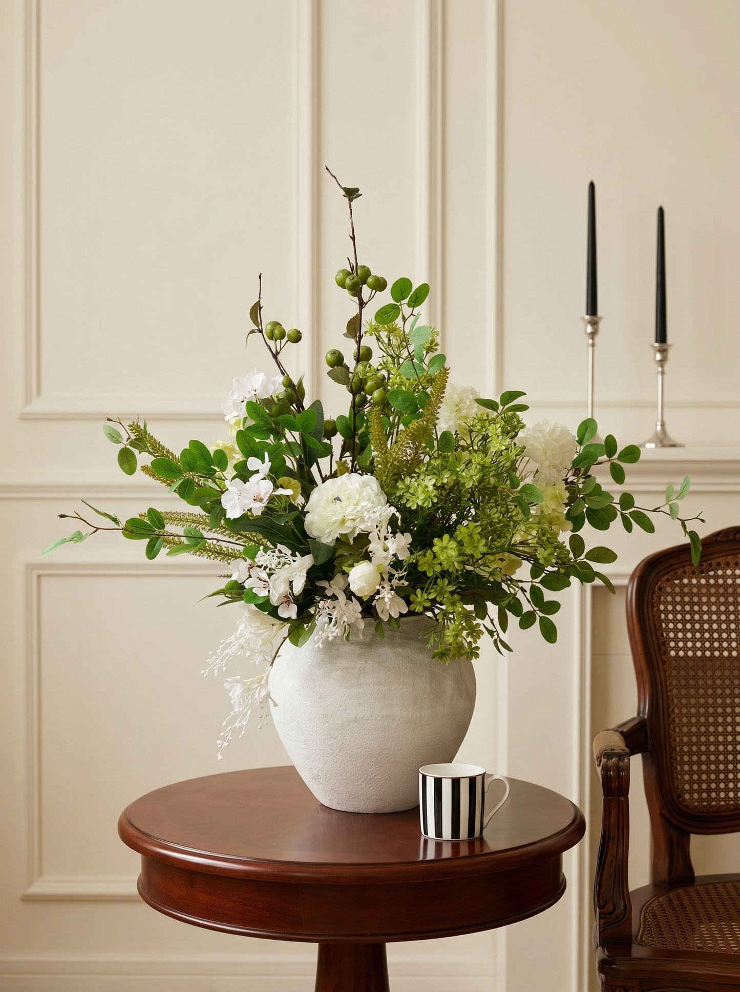 Floral arrangement in a white vase on a wooden table with a neutral background