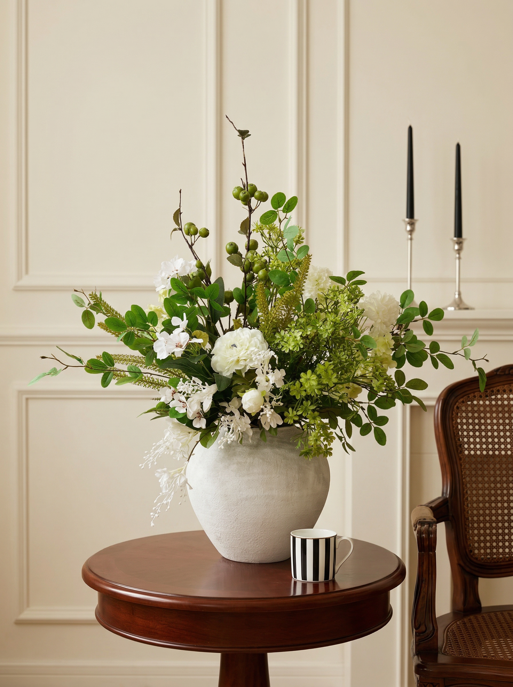 Floral arrangement in a white vase on a wooden table with a neutral background